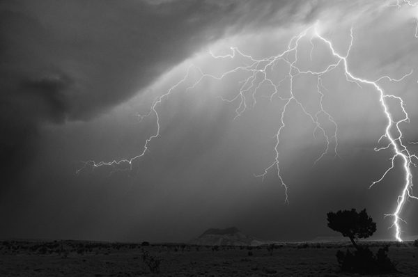 Long exposure of lightning captured at Cerro Cuate hill in San Ysidro New Mexico black and white image photography