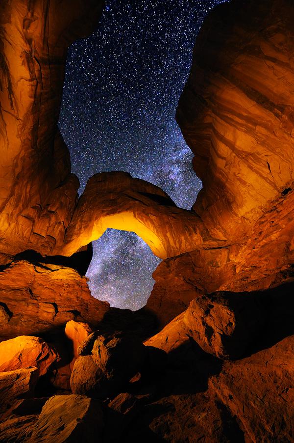 Double long Exposure Nighttime scenic stars rocks arches light painting