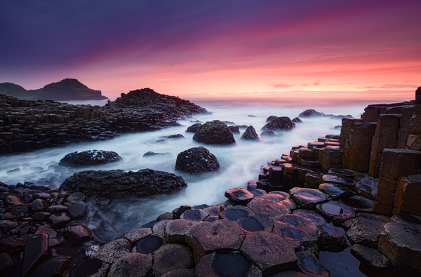 Sunset against basalt pillars pillers cast up by a volcanic eruption in County Antrim Northern Island Giant's Causeway Giant's Causey