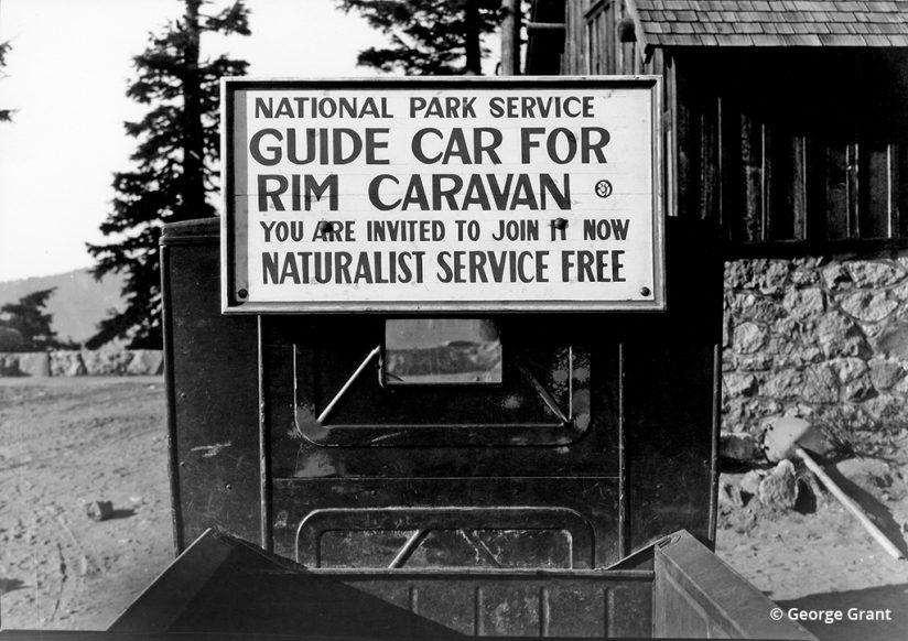 Guide service sign on the rear of a Rim Caravan Guide Car, Crater Lake National Park (1931). Photo by George Grant.